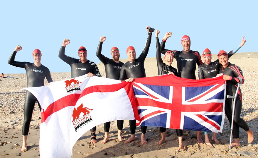 The team celebrating crossing the English Channel on French shores