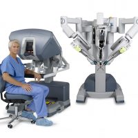 A surgeon sitting by the surgical console which controls the Da Vinci robot which allows for greater accuracy and precision.